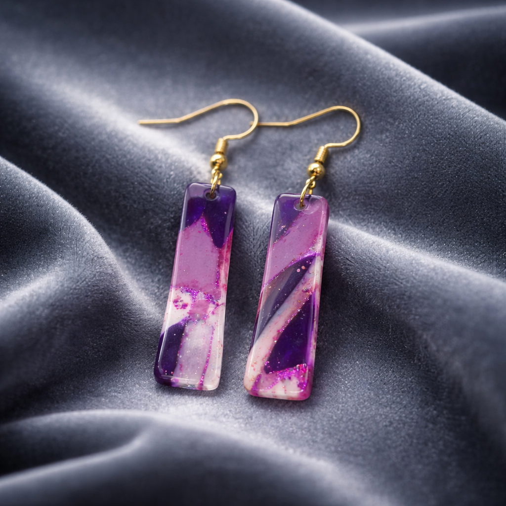 Purple marbled dangling earrings with swirls of pink and purple.