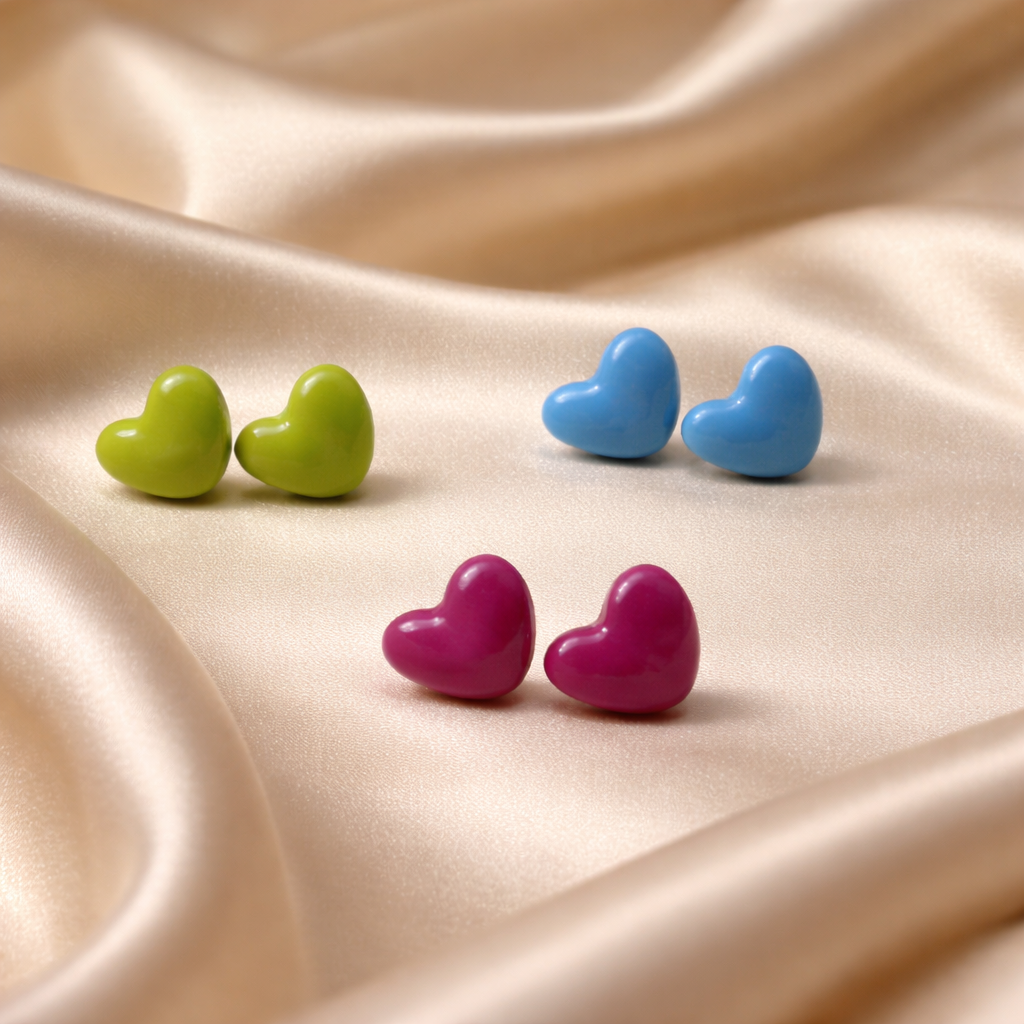 Three pairs of glossy heart stud earrings in green, blue, and pink