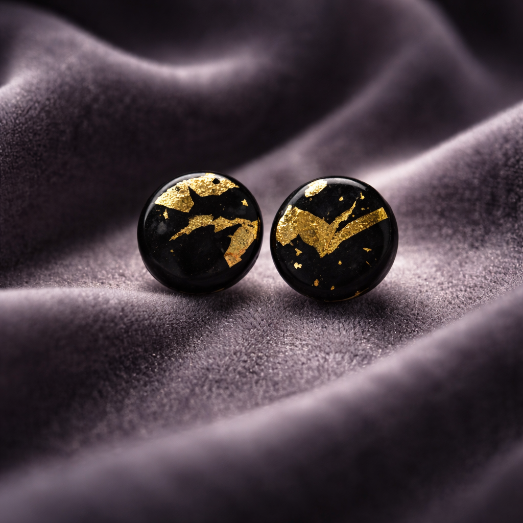 Round black stud earrings with scattered gold flake accents