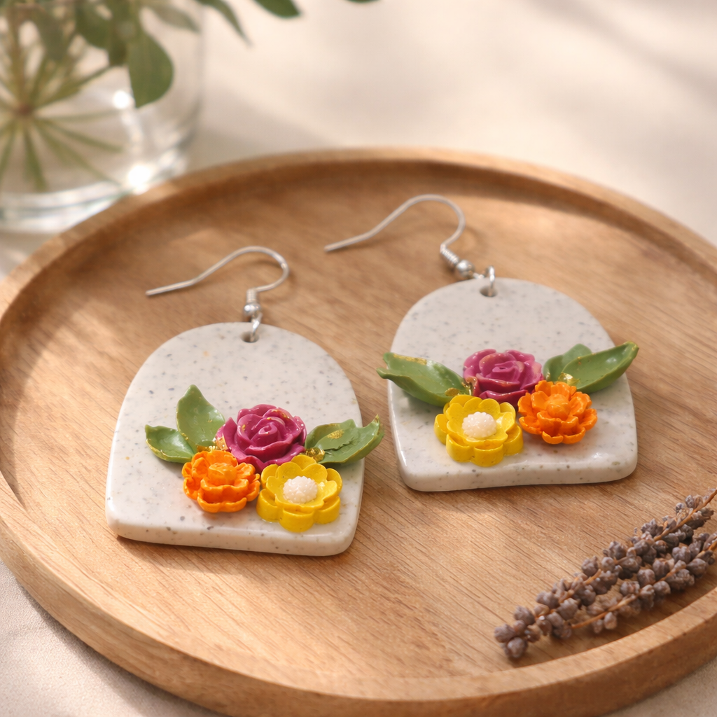 Speckled arch dangle earrings with pink, yellow, and orange flowers