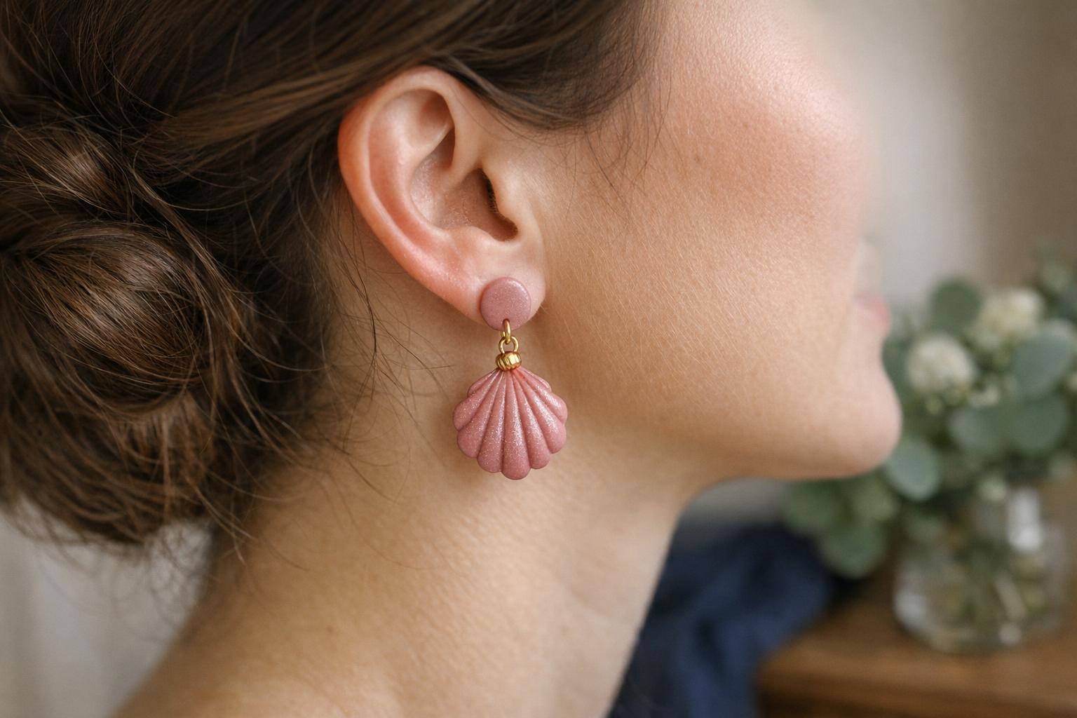 Dusty rose teardrop polymer clay dangle earrings with gold findings styled for a wedding guest look.